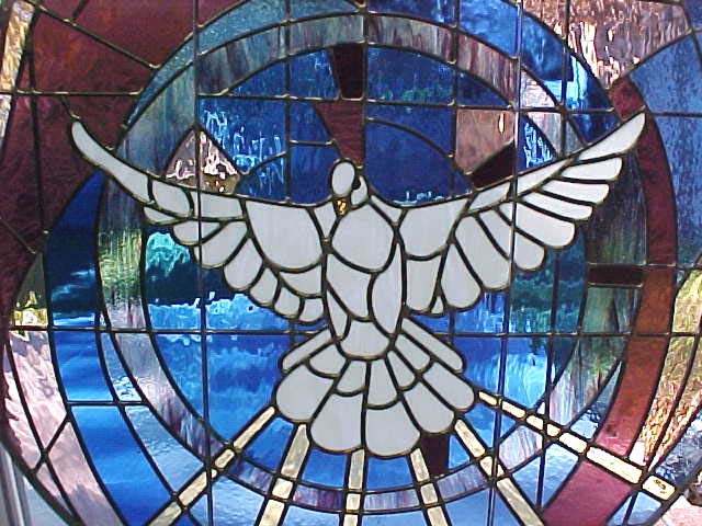 King of Peace's stained glass of the Holy Spirit hovering in creation