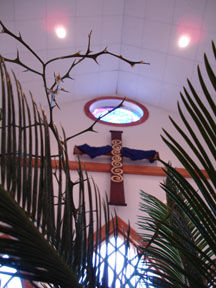 cross seen through palms and thorns