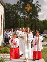 Griffin leads the procession with the cross