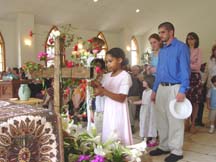 Jessica adds flowers to the cross