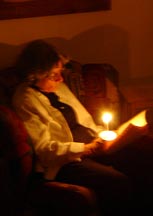 Linda follows the service by candlelight
